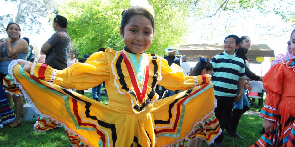 Young girl in yellow traditional Mexican dress