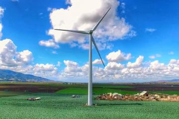 Rendering of large wind turbine in field near farm