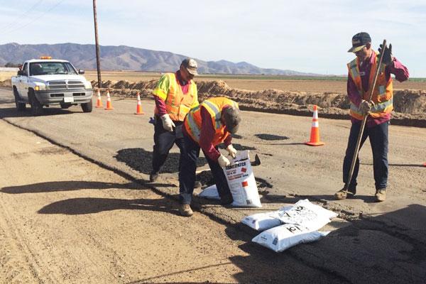 Men working on Gonzales Rd